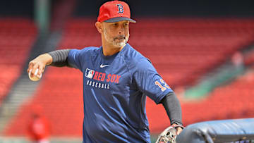 Boston Red Sox manager Alex Cora (13) pitches balls during batting practice before a game against the Toronto Blue Jays at Fenway Park.