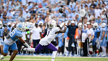Sep 21, 2024; Chapel Hill, North Carolina, USA; James Madison Dukes wide receiver Cam Ross (1) catches a long pass as North Carolina Tar Heels defensive back Alijah Huzzie (28) defends in the second quarter at Kenan Memorial Stadium. Mandatory Credit: Bob Donnan-Imagn Images