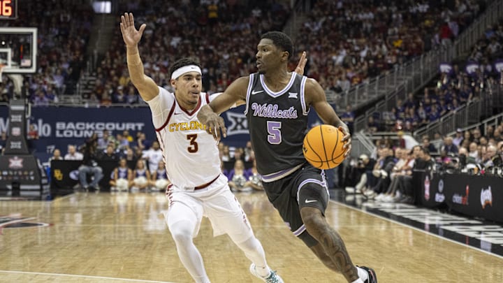 Mar 14, 2024; Kansas City, MO, USA; Kansas State Wildcats guard Cam Carter (5) handles the ball while defended by Iowa State Cyclones guard Tamin Lipsey (3) during the first half at T-Mobile Center. Mandatory Credit: Amy Kontras-Imagn Images