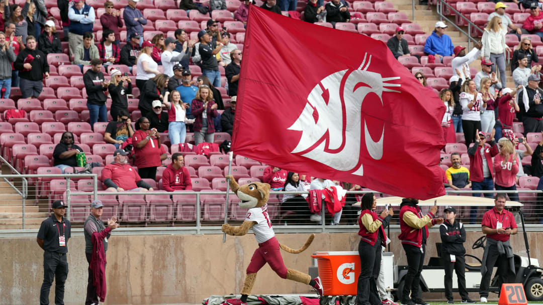 Nov 5, 2022; Stanford, California, USA; Washington State Cougars mascot Butch T. Cougar runs on the field with a flag before the game against the Stanford Cardinal at Stanford Stadium. Mandatory Credit: Darren Yamashita-USA TODAY Sports