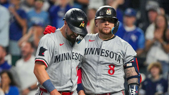 Minnesota Twins shortstop Kyle Farmer (12) reacts with catcher Christian Vázquez (8) against the Kansas City Royals after being tagged out at home in the fourth inning at Kauffman Stadium in Kansas City, Mo., on Sept. 6, 2024.