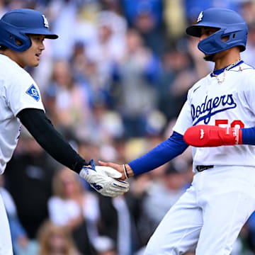 Apr 27, 2025; Los Angeles, California, USA; Los Angeles Dodgers designated hitter Shohei Ohtani (17) celebrates with shortstop Mookie Betts (50) after they scored during the first inning against the Pittsburgh Pirates at Dodger Stadium. Mandatory Credit: Jonathan Hui-Imagn Images