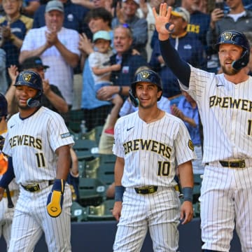 Jun 30, 2024; Milwaukee, Wisconsin, USA;  Milwaukee Brewers second baseman Brice Turang (2) is greeted by right fielder Jackson Chourio (11),  center fielder Sal Frelick (10) and designated hitter Rhys Hoskins (12) after hitting grand slam home run in the fourth inning against the Chicago Cubs at American Family Field.
