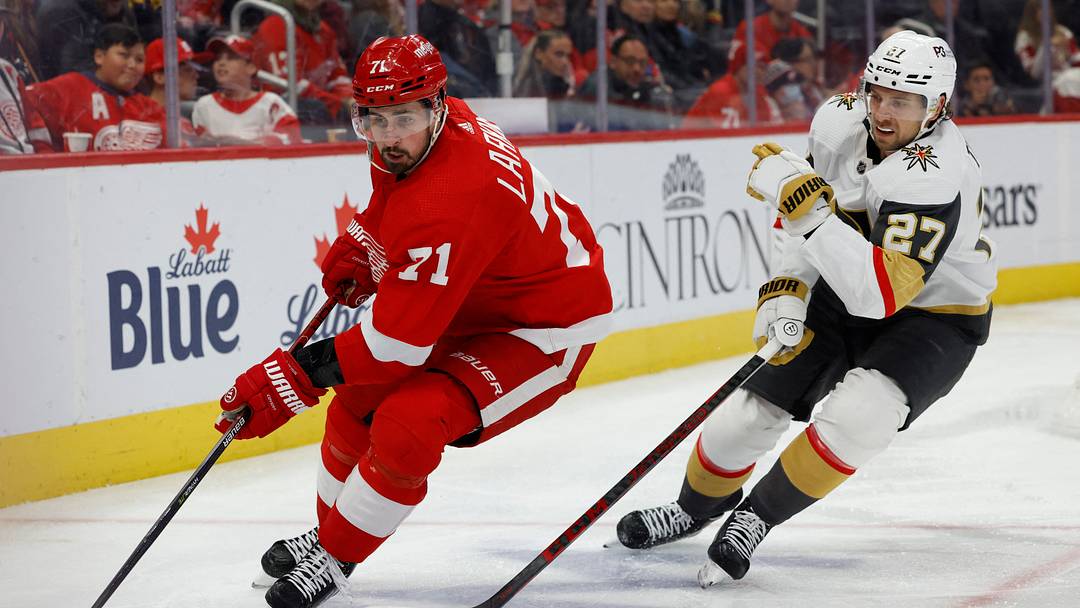 Dec 3, 2022; Detroit, Michigan, USA; Detroit Red Wings center Dylan Larkin (71) skates with the puck against Vegas Golden Knights defenseman Shea Theodore (27) in the second period at Little Caesars Arena. Mandatory Credit: Rick Osentoski-USA TODAY Sports Dec 3, 2022; Detroit, Michigan, USA; Detroit Red Wings center Dylan Larkin (71) skates with the puck against Vegas Golden Knights defenseman Shea Theodore (27) in the second period at Little Caesars Arena. Mandatory Credit: Rick Osentoski-USA TODAY Sports