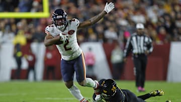 Oct 13, 2025; Landover, Maryland, USA; Chicago Bears wide receiver DJ Moore (2) escapes the tackle of Washington Commanders safety Jeremy Reaves (39) during the first quarter at Northwest Stadium. Mandatory Credit: Peter Casey-Imagn Images