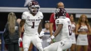 Sep 30, 2023; Arlington, Texas, USA; Texas A&M Aggies wide receiver Evan Stewart (1) and wide receiver Ainias Smith (0) In action during the game between the Texas A&M Aggies and the Arkansas Razorbacks at AT&T Stadium. Mandatory Credit: Jerome Miron-USA TODAY Sports