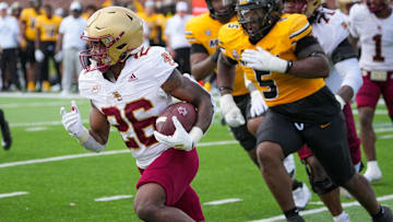 Sep 14, 2024; Columbia, Missouri, USA; Boston College Eagles running back Datrell Jones (26) runs the ball as Missouri Tigers defensive tackle Kristian Williams (5) chases during the first half at Faurot Field at Memorial Stadium. Mandatory Credit: Denny Medley-Imagn Images