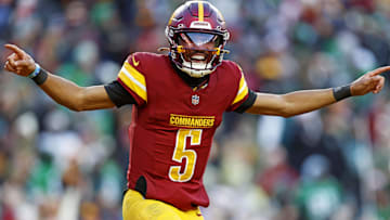 Dec 22, 2024; Landover, Maryland, USA; Washington Commanders quarterback Jayden Daniels (5) celebrates after throwing a touchdown during the fourth quarter against the Philadelphia Eagles at Northwest Stadium. Mandatory Credit: Peter Casey-Imagn Images