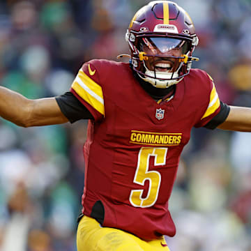 Dec 22, 2024; Landover, Maryland, USA; Washington Commanders quarterback Jayden Daniels (5) celebrates after throwing a touchdown during the fourth quarter against the Philadelphia Eagles at Northwest Stadium. Mandatory Credit: Peter Casey-Imagn Images