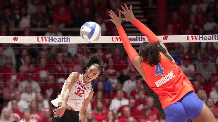 Wisconsin outside hitter Grace Egan (32) hits the ball past Florida middle blocker Brooklyn Briscoe (4) during their match Wednesday, Sept. 2, 2026 at the UW Field House in Madison, Wisconsin. Wisconsin outside hitter Grace Egan (32) hits the ball past Florida middle blocker Brooklyn Briscoe (4) during their match Wednesday, Sept. 2, 2026 at the UW Field House in Madison, Wisconsin.