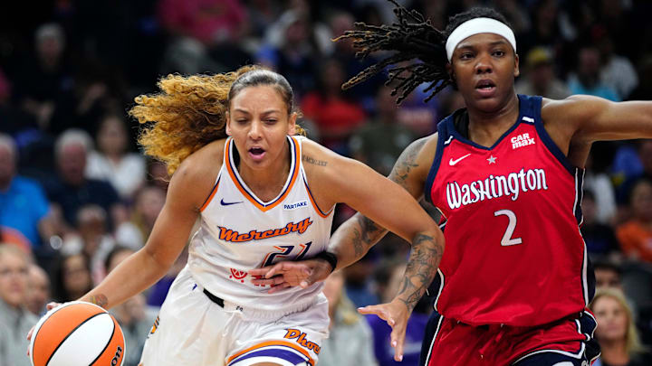 Mercury Mikiah Herbert Harrigan (21) drives on Mystics forward Myisha Hines-Allen (2) during a game at the Footprint Center in Phoenix at Thursday, May 23, 2024. Mercury Mikiah Herbert Harrigan (21) drives on Mystics forward Myisha Hines-Allen (2) during a game at the Footprint Center in Phoenix at Thursday, May 23, 2024.