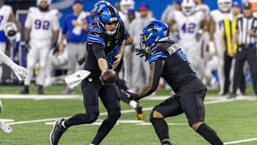 Dec 15, 2024; Detroit, Michigan, USA; Detroit Lions quarterback Jared Goff (16) hands off to running back David Montgomery (5) during the first quarter against the Buffalo Bills at Ford Field. Mandatory Credit: David Reginek-Imagn Images