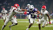 Kansas State Dylan Edwards (3) stiff arms Rutgers cornerback Jesse Ofurie on his way to the go-ahead touchdown during second half of the Rate Bowl at Chase Field on Dec. 26, 2024, in Phoenix.