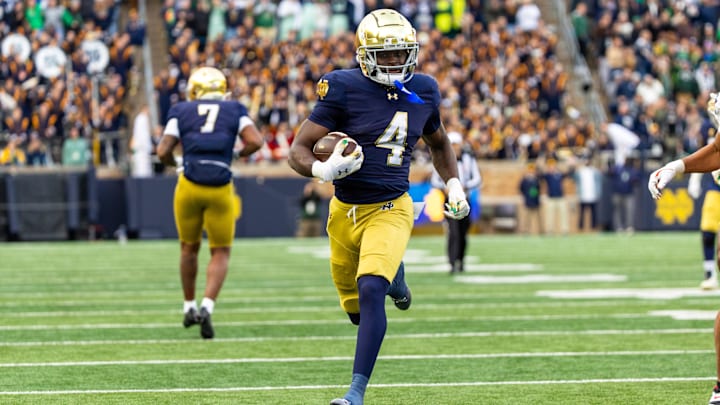 Nov 22, 2025; South Bend, Indiana, USA; Notre Dame Fighting Irish running back Jeremiyah Love (4) breaks loose for a touchdown run against the Syracuse Orange during the first half at Notre Dame Stadium. Mandatory Credit: Michael Caterina-Imagn Images