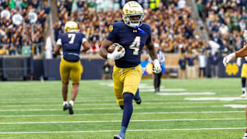 Nov 22, 2025; South Bend, Indiana, USA; Notre Dame Fighting Irish running back Jeremiyah Love (4) breaks loose for a touchdown run against the Syracuse Orange during the first half at Notre Dame Stadium. Mandatory Credit: Michael Caterina-Imagn Images