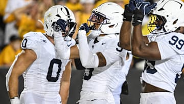 Penn State Nittany Lions cornerback Elliot Washington II (9) reacts with defensive end Yvan Kemajou (99) and linebacker Dominic Deluca (0) after returning a blocked field goal attempt by Iowa Hawkeyes kicker Drew Stevens