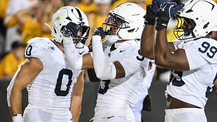 Penn State Nittany Lions cornerback Elliot Washington II (9) reacts with defensive end Yvan Kemajou (99) and linebacker Dominic Deluca (0) after returning a blocked field goal attempt by Iowa Hawkeyes kicker Drew Stevens