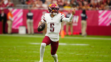 Commanders quarterback Jayden Daniels (5) looks for open receivers against the Cardinals during a game at State Farm Stadium in Glendale on Sept. 29, 2024.