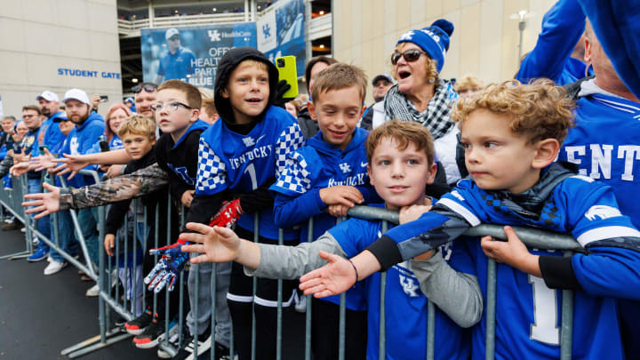 Oct 14, 2023; Lexington, Kentucky, USA; Young Kentucky Wildcats fans look to get a high five from players at Cat Walk before the game against the Missouri Tigers at Kroger Field. Mandatory Credit: Jordan Prather-USA TODAY Sports