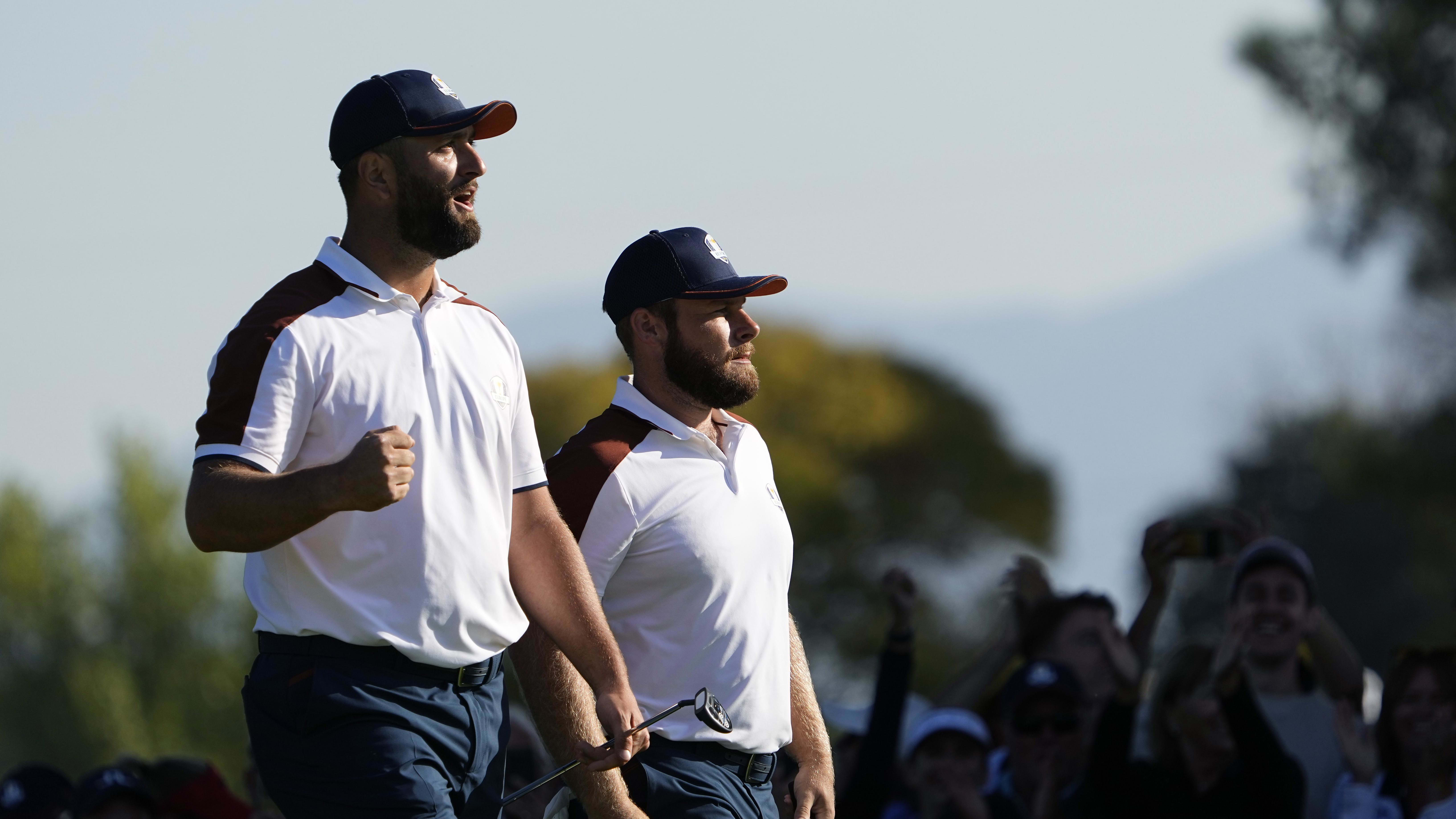 Team Europe golfers Tyrrell Hatton and Jon Rahm celebrate after a putt during the 2023 Ryder Cup.