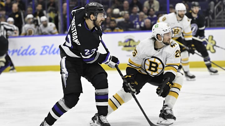 Apr 4, 2026; Tampa, Florida, USA; Tampa Bay Lightning right wing Oliver Bjorkstrand (22) battles for the puck against Boston Bruins defenseman Andrew Peeke (26) during the third period at Benchmark International Arena. Mandatory Credit: Pablo Robles-Imagn Images Apr 4, 2026; Tampa, Florida, USA; Tampa Bay Lightning right wing Oliver Bjorkstrand (22) battles for the puck against Boston Bruins defenseman Andrew Peeke (26) during the third period at Benchmark International Arena. Mandatory Credit: Pablo Robles-Imagn Images
