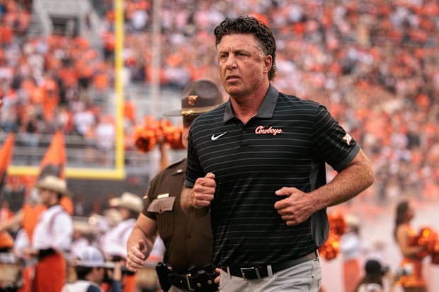 Former Oklahoma State coach Mike Gundy takes the field.