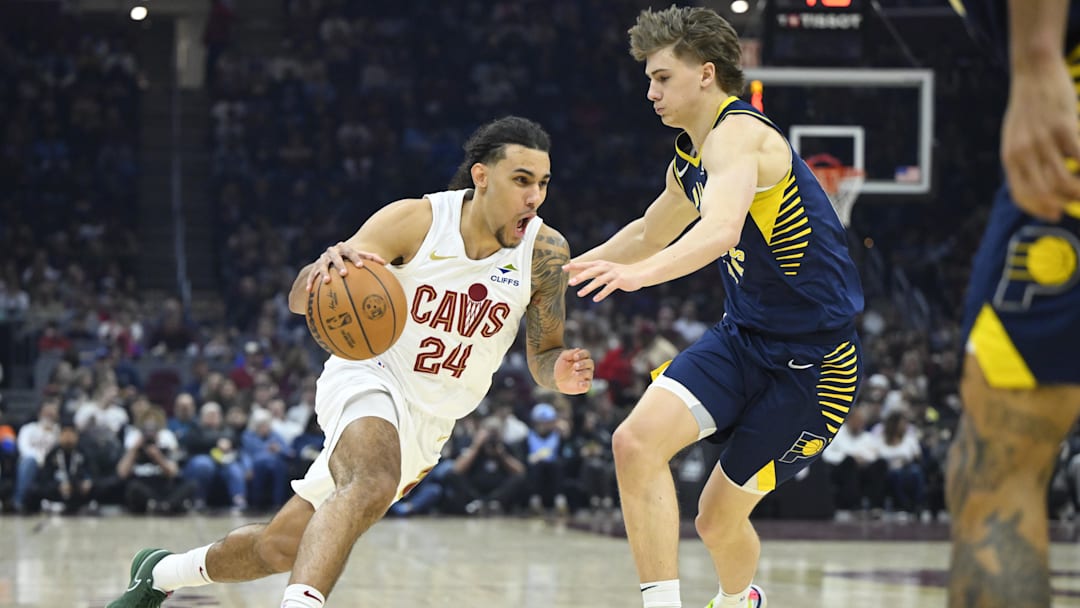 Apr 13, 2025; Cleveland, Ohio, USA; Cleveland Cavaliers forward Jaylon Tyson (24) dribbles beside Indiana Pacers forward Johnny Furphy (12) in the first quarter at Rocket Arena. Mandatory Credit: David Richard-Imagn Images