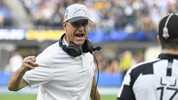 Nov 10, 2024; Inglewood, California, USA; Los Angeles Chargers head coach Jim Harbaugh argues with referee Brett Bergman (17) over a fumble call during the second quarter at SoFi Stadium. Mandatory Credit: Robert Hanashiro-Imagn Images