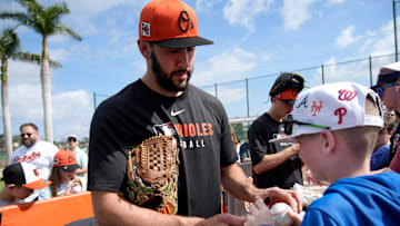 Orioles right-hand pitcher Grayson Rodriguez signs an autograph for fan Charlie Brose, 11, from Pittsburgh, Pennsylvania. The Baltimore Orioles held their first full-squad workout of spring training on Tuesday, Feb. 18, 2025.