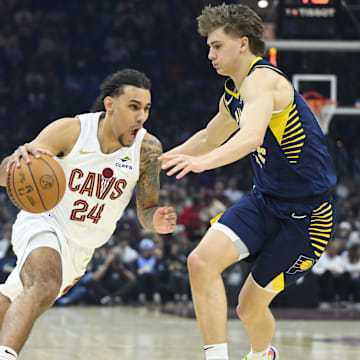 Apr 13, 2025; Cleveland, Ohio, USA; Cleveland Cavaliers forward Jaylon Tyson (24) dribbles beside Indiana Pacers forward Johnny Furphy (12) in the first quarter at Rocket Arena. Mandatory Credit: David Richard-Imagn Images