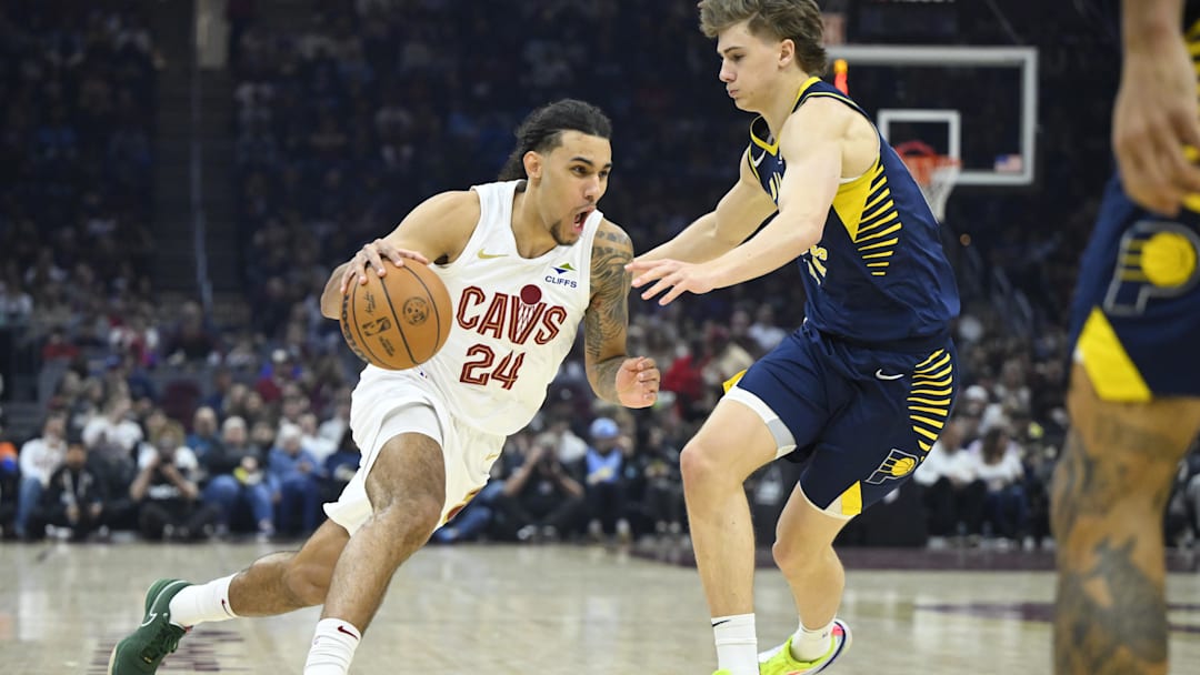 Apr 13, 2025; Cleveland, Ohio, USA; Cleveland Cavaliers forward Jaylon Tyson (24) dribbles beside Indiana Pacers forward Johnny Furphy (12) in the first quarter at Rocket Arena. Mandatory Credit: David Richard-Imagn Images