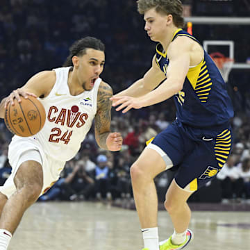 Apr 13, 2025; Cleveland, Ohio, USA; Cleveland Cavaliers forward Jaylon Tyson (24) dribbles beside Indiana Pacers forward Johnny Furphy (12) in the first quarter at Rocket Arena. Mandatory Credit: David Richard-Imagn Images
