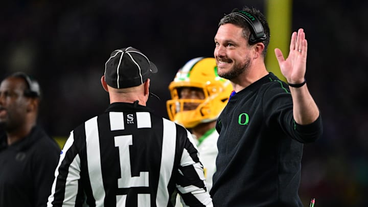 Oct 18, 2024; West Lafayette, Indiana, USA; Oregon Ducks head coach Dan Lanning holds his hand up and smiles while talking to a referee during the first quarter at Ross-Ade Stadium. Mandatory Credit: Marc Lebryk-Imagn Images