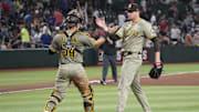 Aug 6, 2025; Phoenix, Arizona, USA; San Diego Padres catcher Freddy Fermin (54) and San Diego Padres pitcher Mason Miller (22) celebrate against the Arizona Diamondbacks after the ninth inning at Chase Field. Mandatory Credit: Joe Camporeale-Imagn Images