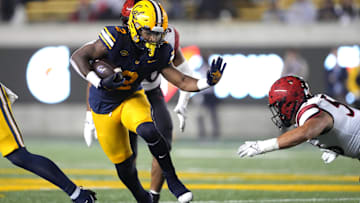 Sep 14, 2024; Berkeley, California, USA; California Golden Bears running back Kadarius Calloway (2) carries the ball against San Diego State Aztecs linebacker DJ Herman (right) during the fourth quarter at California Memorial Stadium. Mandatory Credit: Darren Yamashita-Imagn Images