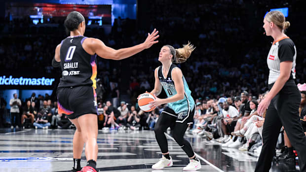 New York Liberty guard Sabrina Ionescu looks to shoot the ball as Phoenix Mercury forward Satou Sabally defends.