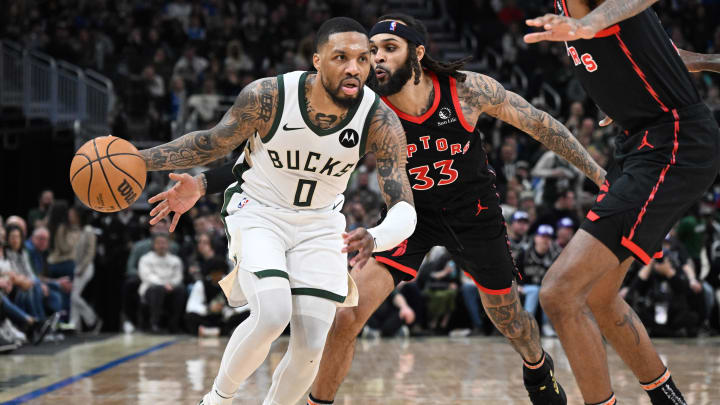 Milwaukee Bucks guard Damian Lillard (0) drives to the basket against Toronto Raptors guard Gary Trent Jr. (33) in the second half at Fiserv Forum. 