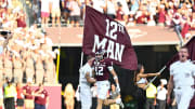 Sep 2, 2023; College Station, Texas, USA; /Texas A&M Aggies linebacker Sam Mathews (12) runs the 12th Man flag out prior to the game against the New Mexico Lobos at Kyle Field. Mandatory Credit: Maria Lysaker-USA TODAY Sports