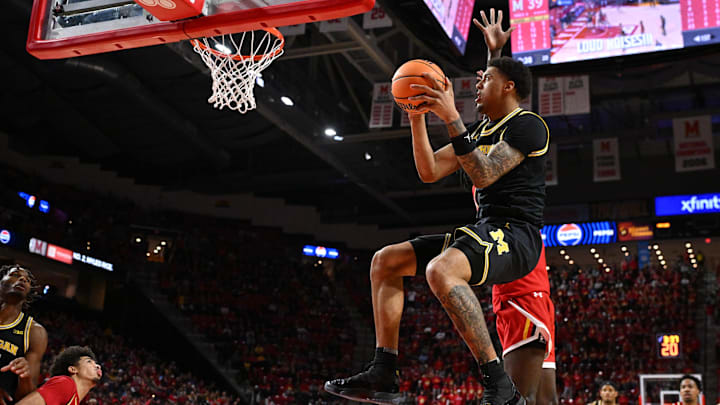 Dec 13, 2025; College Park, Maryland, USA;  Michigan Wolverines forward Yaxel Lendeborg (23) drives to the basket for a lay up in the first half against the Maryland Terrapins at Xfinity Center. Mandatory Credit: Jamie Sabau-Imagn Images