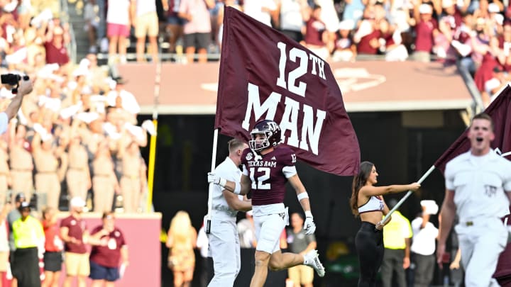 Sep 2, 2023; College Station, Texas, USA; /Texas A&M Aggies linebacker Sam Mathews (12) runs the 12th Man flag out prior to the game against the New Mexico Lobos at Kyle Field. Mandatory Credit: Maria Lysaker-USA TODAY Sports