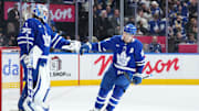 Dec 15, 2024; Toronto, Ontario, CAN; Toronto Maple Leafs center John Tavares (91) scores a goal and celebrates with the goaltender Dennis Hildeby (35) against the Buffalo Sabres during the second period at Scotiabank Arena. Mandatory Credit: Nick Turchiaro-Imagn Images