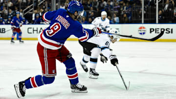 Oct 12, 2024; New York, New York, USA; New York Rangers defenseman Jacob Trouba (8) shoots the puck as Utah Hockey Club left wing Matias Maccelli (63) defends during the second period at Madison Square Garden. Mandatory Credit: John Jones-Imagn Images