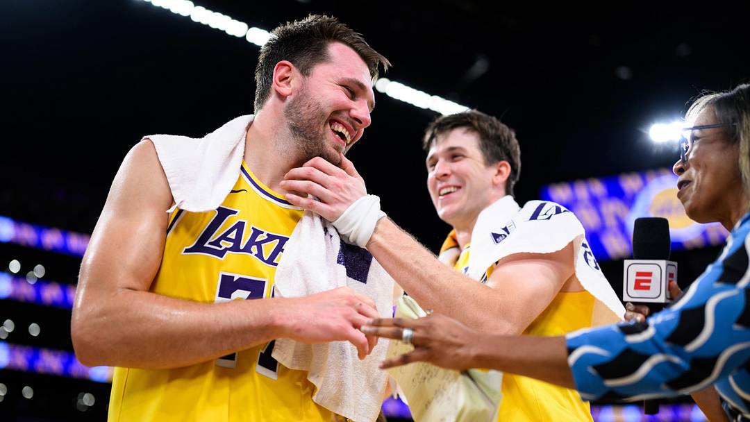 Mar 14, 2026; Los Angeles, California, USA; Los Angeles Lakers guard Luka Doncic (77) reacts with guard Austin Reaves (15) after scoring a game winning shot during overtime against the Denver Nuggets at Crypto.com Arena. Mandatory Credit: William Liang-Imagn Images