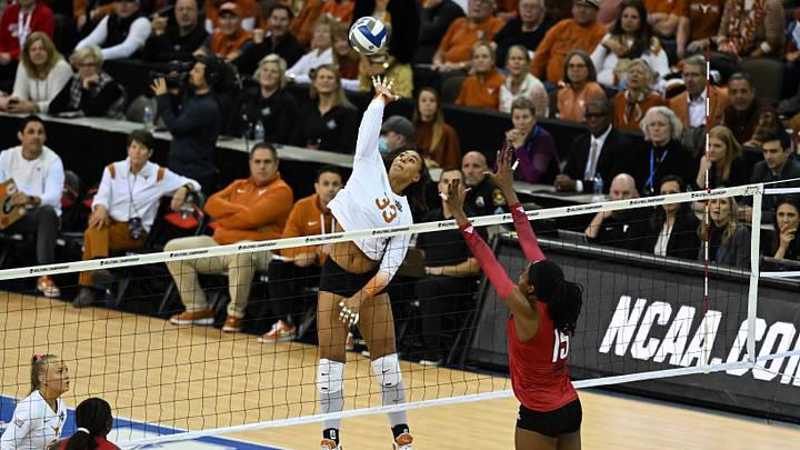 Dec 17, 2022; Omaha, Nebraska, US;  Texas Longhorns Logan Eggleston (33) attacks against Louisville Cardinals Aiko Jones (15) at CHI Health Center. Mandatory Credit: Steven Branscombe-USA TODAY Sports