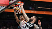 Apr 11, 2025; Phoenix, Arizona, USA; Phoenix Suns center Oso Ighodaro (4) dunks over San Antonio Spurs forward Sandro Mamukelashvili (54) during the second half at Footprint Center. Mandatory Credit: Joe Camporeale-Imagn Images