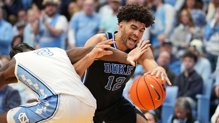 Feb 7, 2026; Chapel Hill, North Carolina, USA;  North Carolina Tar Heels forward Caleb Wilson (8) and Duke Blue Devils forward Cameron Boozer (12) fight for the ball in the first half.