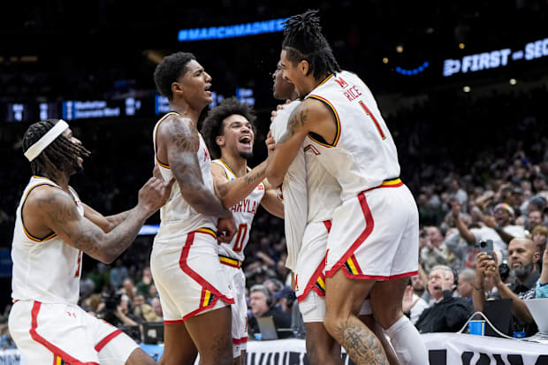 Maryland Terrapins center Derik Queen (25) celebrates with teammates after scoring the game-winning shot.