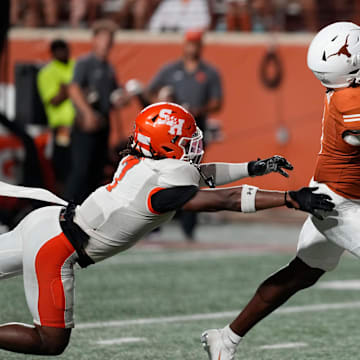 Sep 20, 2025; Austin, Texas, USA; Texas Longhorns wide receiver Ryan Wingo (1) catches a pass for a touchdown over Sam Houston Bearkats linebacker Emon Allen (7) during the second half at Darrell K Royal-Texas Memorial Stadium. Mandatory Credit: Scott Wachter-Imagn Images