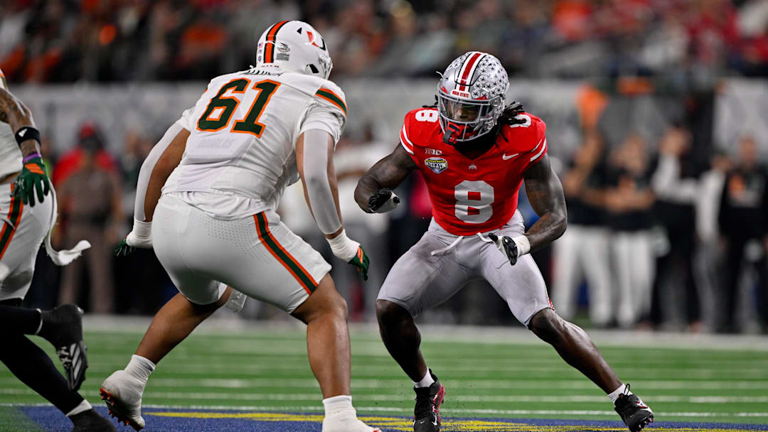Dec 31, 2025; Arlington, TX, USA; Miami Hurricanes offensive lineman Francis Mauigoa (61) blocks Ohio State Buckeyes linebacker Arvell Reese (8) during the 2025 Cotton Bowl and quarterfinal game of the College Football Playoff at AT&T Stadium. Mandatory Credit: Jerome Miron-Imagn Images