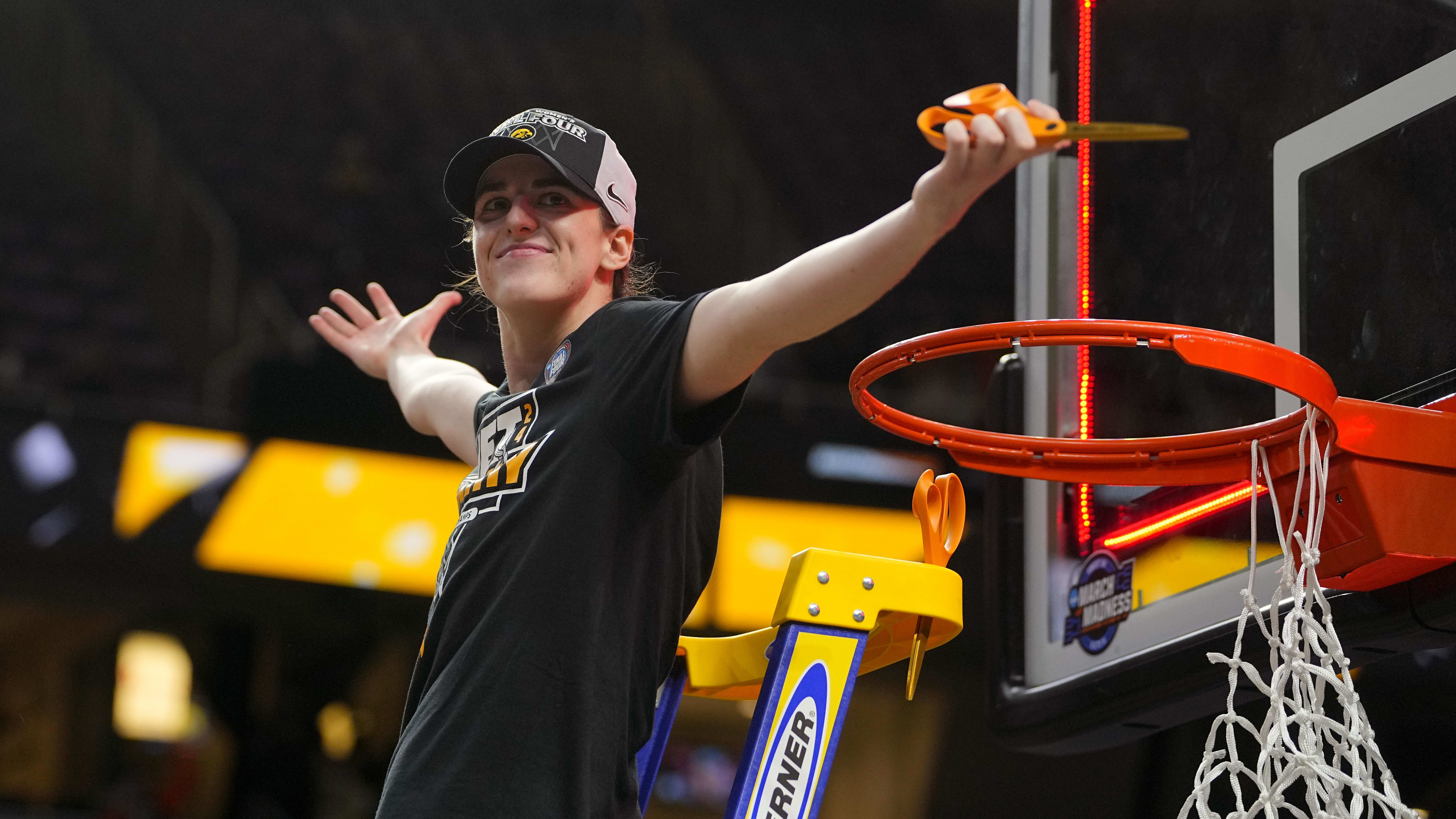 Iowa Hawkeyes guard Caitlin Clark cuts the net after defeating LSU in the Elite Eight. 